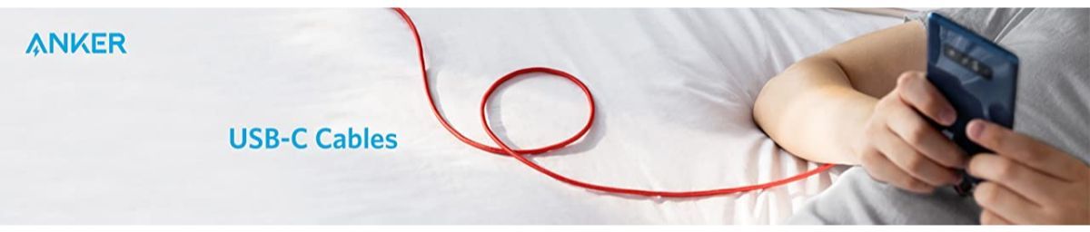 Anker USB-C cable charging phone on bed, red cable coiled, Anker Kuwait