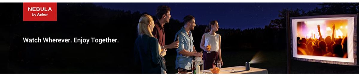 Nebula by Anker portable projector displaying concert on outdoor screen at night with friends enjoying together