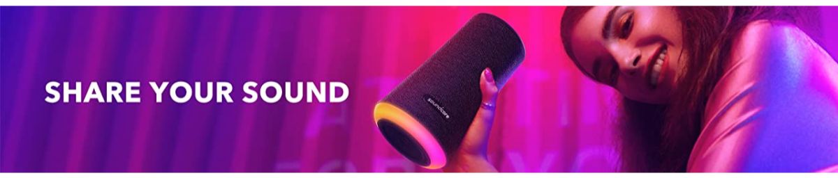Anker portable Bluetooth speaker with colorful lighting, held by smiling woman — Anker Kuwait
