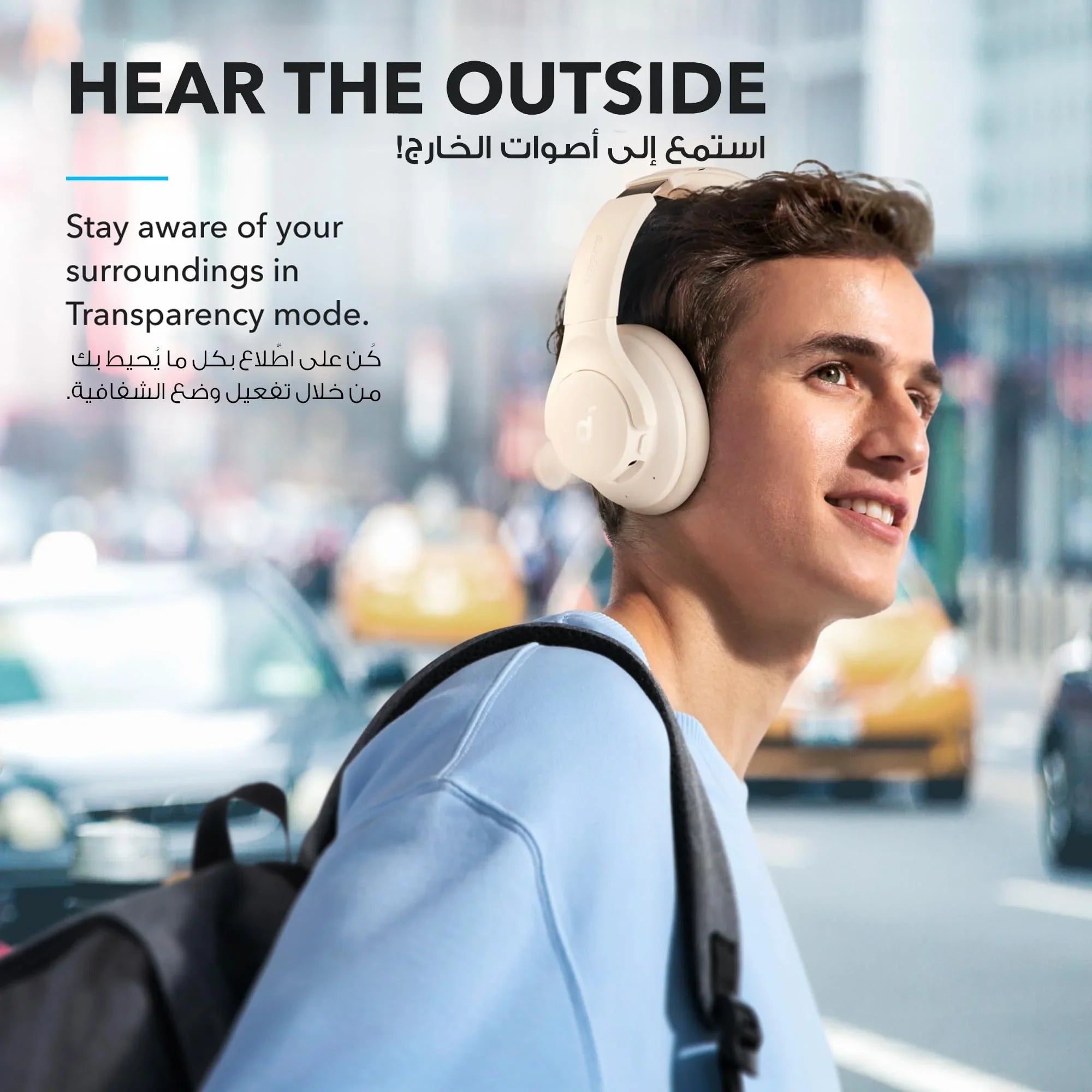 Man wearing white over-ear headphones with Transparency mode in city, Anker Kuwait