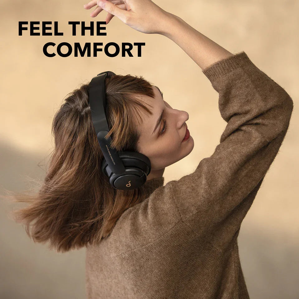 Woman enjoying comfort with black over-ear headphones, Anker Kuwait