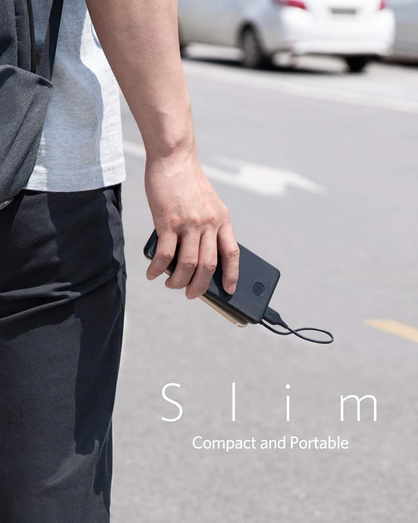 Slim portable power bank held in hand, compact design for on-the-go charging, Anker Kuwait