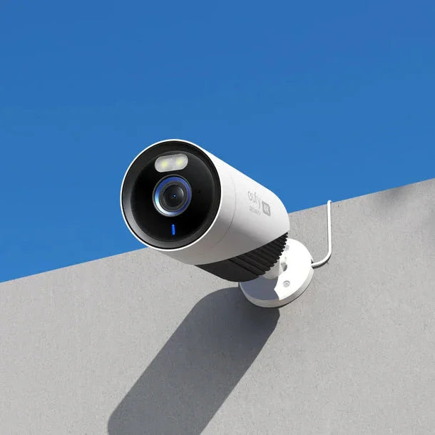 Eufy outdoor security camera mounted on wall under blue sky, Anker Kuwait