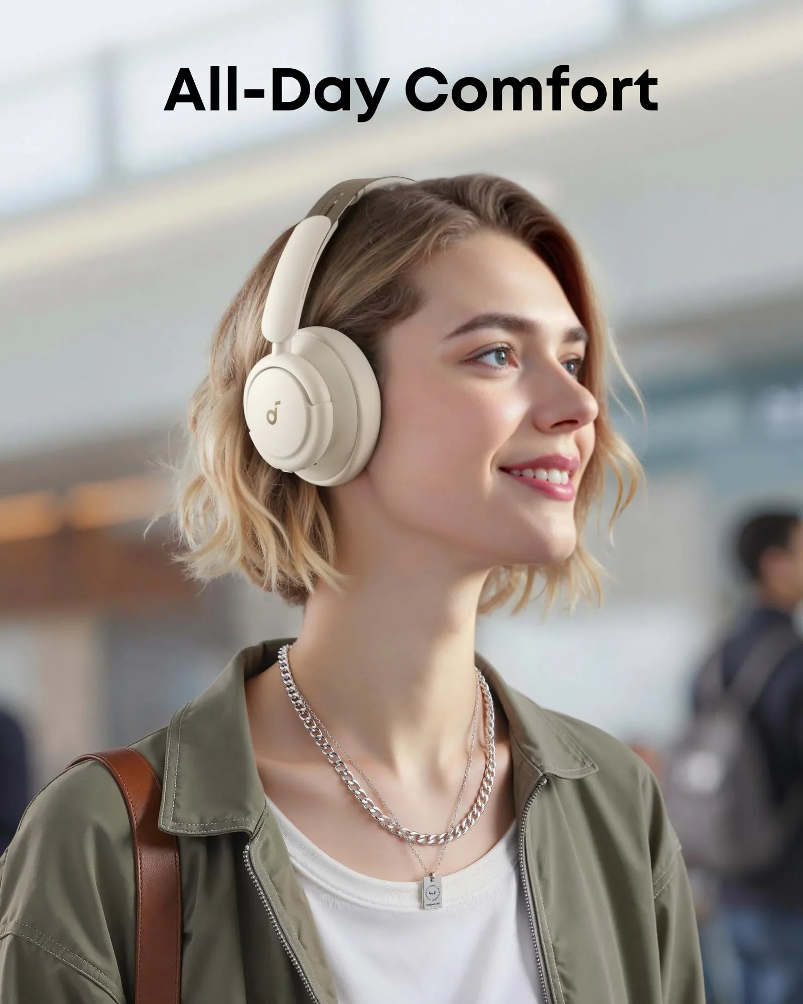 Woman wearing cream over-ear headphones for all-day comfort, Anker Kuwait