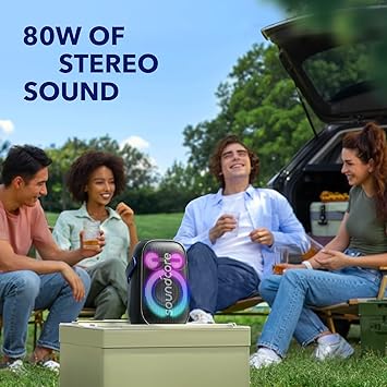 Anker Soundcore portable speaker with 80W stereo sound, enjoyed outdoors by friends at a picnic in Kuwait