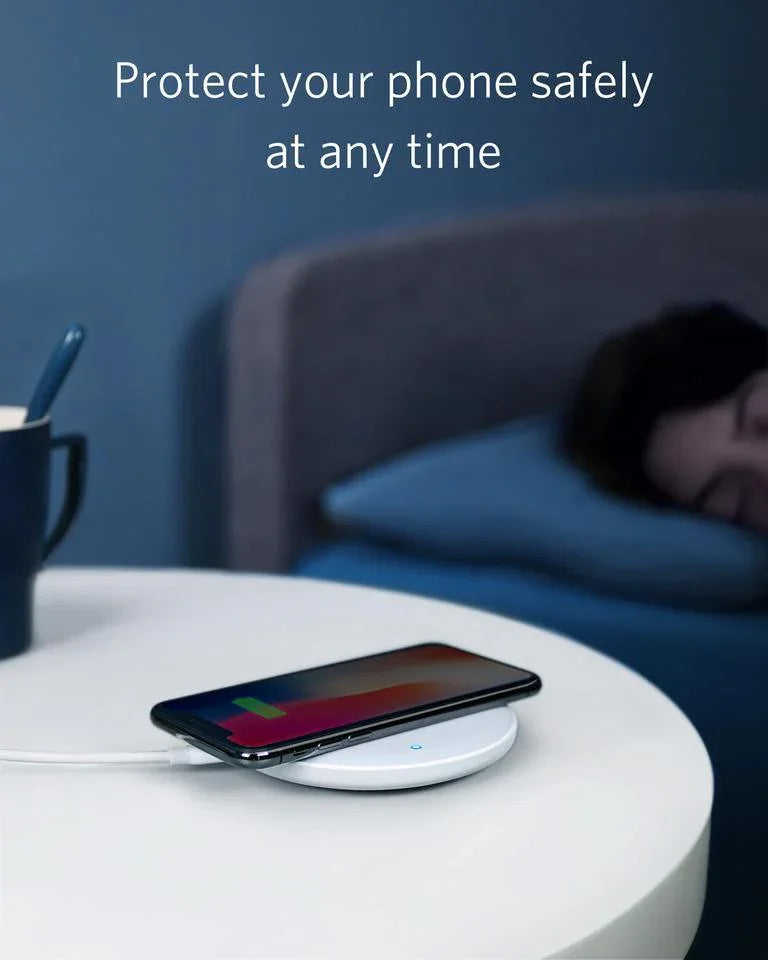 Wireless phone charger on nightstand beside sleeping person, Anker Kuwait