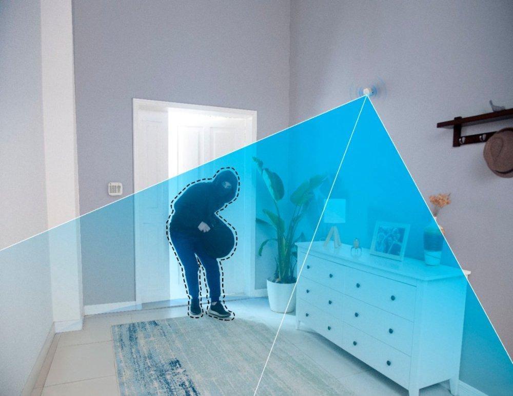 Smart home security camera detects intruder in living room with blue motion zone overlay